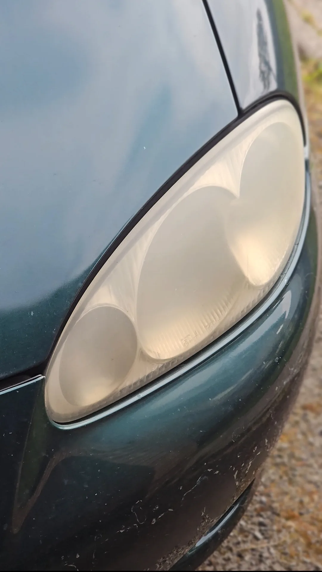 Headlight restoration before in Plymouth